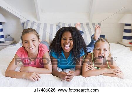 Three Young Friends Lying Down Next To Each Other View Large Photo Image Stock Photograph - Three Young Friends Lying Down Next To Each Other. Fotosearch