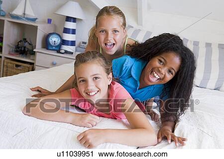 Three Young Friends Lying On Top Of Each Other View Large Photo Image Stock Image - Three Young Friends Lying On Top Of Each Other. Fotosearch