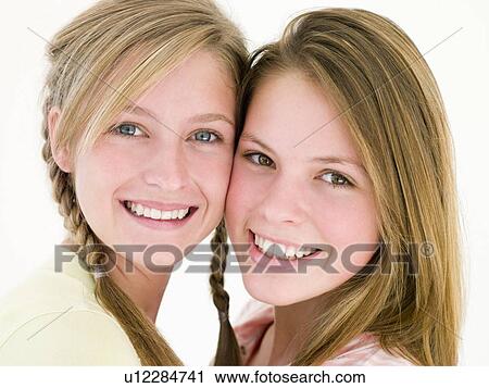 Two girl friends together smiling View Large Photo Image Stock Image - Two girl friends together smiling. Fotosearch