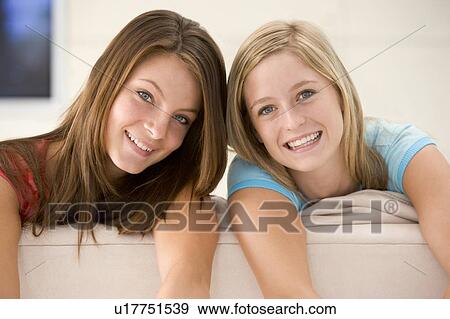Two women in living room smiling View Large Photo Image Stock Photo - Two women in living room smiling. Fotosearch