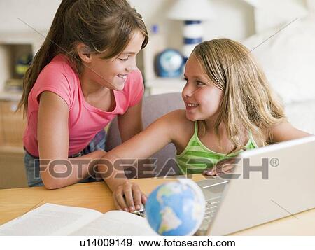 Two Young Girls Doing Homework On A Laptop View Large Photo Image Stock Photo - Two Young Girls Doing Homework On A Laptop. Fotosearch