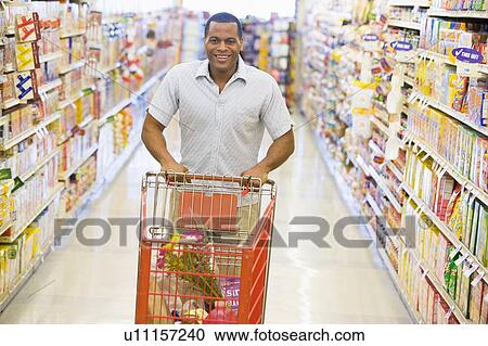 Man shopping at grocery store View Large Photo Image Stock Image - Man shopping at grocery store. Fotosearch