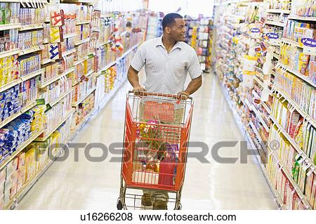Stock Photo - Man shopping at grocery store. Fotosearch