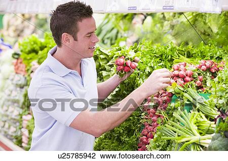 Man shopping for beets at a grocery store View Large Photo Image Stock Image - Man shopping for beets at a grocery store. Fotosearch