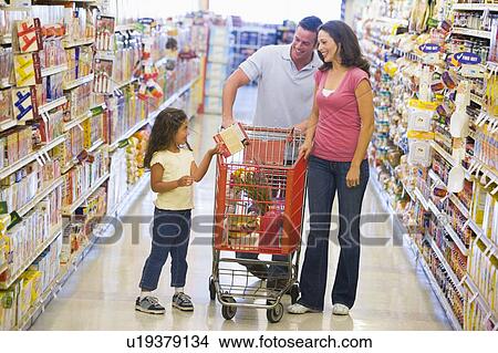 Mother and father with young daughter shopping at the grocery store. View Large Photo Image Picture - Mother and father with young daughter shopping at the grocery store.. Fotosearch