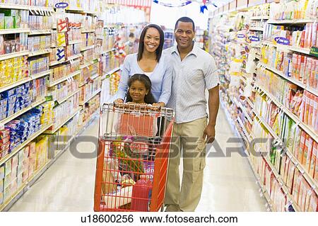 Mother and father with young daughter shopping at the grocery store. View Large Photo Image Stock Photograph - Mother and father with young daughter shopping at the grocery store.. Fotosearch