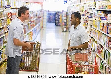 Stock Photograph - Two men talking to each other at a grocery store. Fotosearch