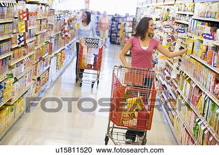 Stock Image - Two women shopping at a grocery store. Fotosearch