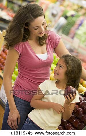 Woman and daughter shopping for apples at a grocery store View Large Photo Image Stock Photography - Woman and daughter shopping for apples at a grocery store. Fotosearch