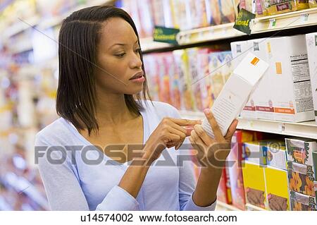 Woman shopping at a grocery store View Large Photo Image Stock Image - Woman shopping at a grocery store. Fotosearch