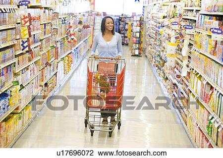 Woman shopping at a grocery store View Large Photo Image Stock Image - Woman shopping at a grocery store. Fotosearch