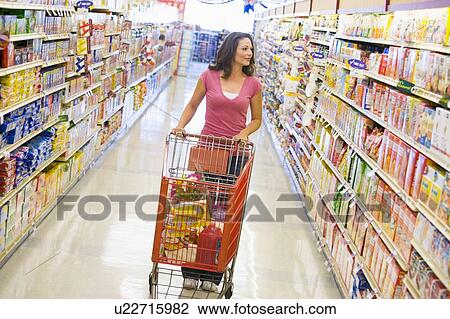 Woman shopping at a grocery store View Large Photo Image Stock Image - Woman shopping at a grocery store. Fotosearch