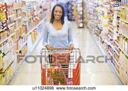 Woman shopping at a grocery store View Large Photo Image Stock Photo - Woman shopping at a grocery store. Fotosearch