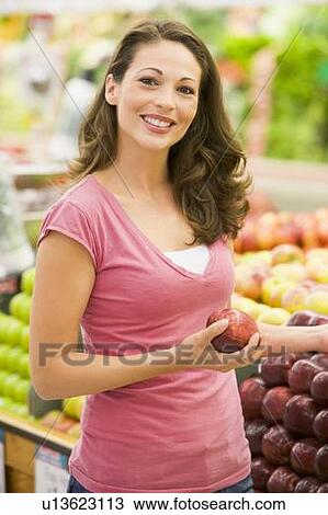 Woman shopping for apples at a grocery store View Large Photo Image Stock Image - Woman shopping for apples at a grocery store. Fotosearch