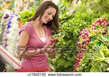 Woman shopping for beets at a grocery store View Large Photo Image Stock Image - Woman shopping for beets at a grocery store. Fotosearch