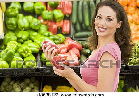 Woman shopping for bell peppers at a grocery store View Large Photo Image Stock Image - Woman shopping for bell peppers at a grocery store. Fotosearch