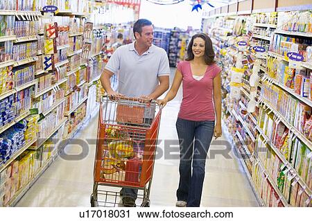 Young couple shopping at a grocery store View Large Photo Image Stock Image - Young couple shopping at a grocery store. Fotosearch