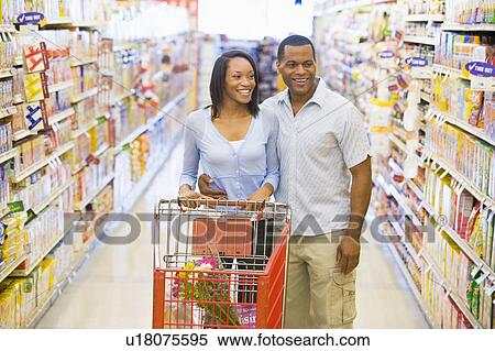 Young couple shopping at a grocery store View Large Photo Image Stock Photography - Young couple shopping at a grocery store. Fotosearch