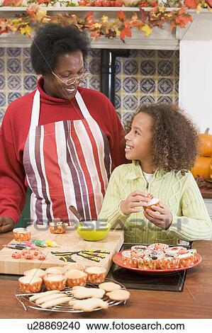Grandmother and granddaughter making Halloween treats and smiling View Large Photo Image Stock Image - Grandmother and granddaughter making Halloween treats and smiling. Fotosearch