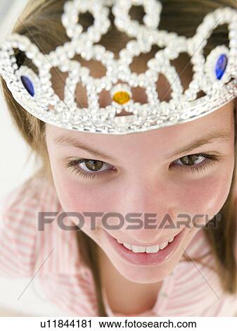 Stock Image - Teenage girl wearing crown and smiling. Fotosearch