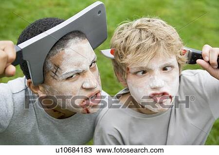 Two young boys with scary Halloween make up and plastic knives through their heads View Large Photo Image Stock Image - Two young boys with scary Halloween make up and plastic knives through their heads. Fotosearch