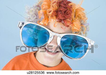 Young boy wearing clown wig and sunglasses smiling View Large Photo Image Stock Photograph - Young boy wearing clown wig and sunglasses smiling. Fotosearch