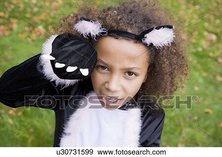 Young girl outdoors in cat costume on Halloween View Large Photo Image Stock Photo - Young girl outdoors in cat costume on Halloween. Fotosearch