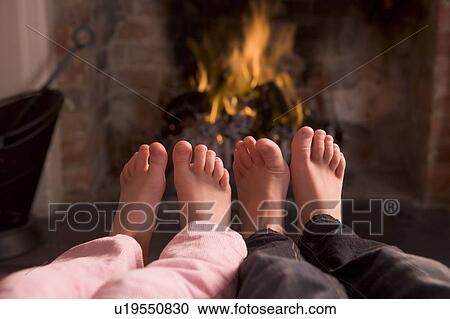 Children's feet warming at a fireplace View Large Photo Image Stock Image - Children's feet warming at a fireplace. Fotosearch