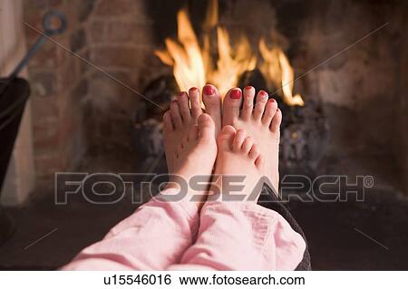 Mother and daughter's feet warming at a fireplace View Large Photo Image Stock Photograph - Mother and daughter's feet warming at a fireplace. Fotosearch