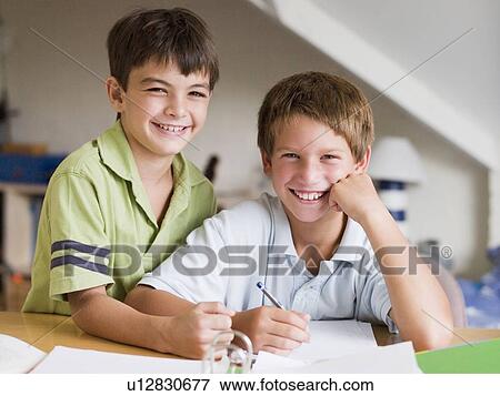 Two Young Boys Doing Their Homework Together View Large Photo Image Stock Photo - Two Young Boys Doing Their Homework Together. Fotosearch