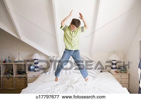 Young Boy Jumping On His Bed View Large Photo Image Stock Photo - Young Boy Jumping On His Bed. Fotosearch