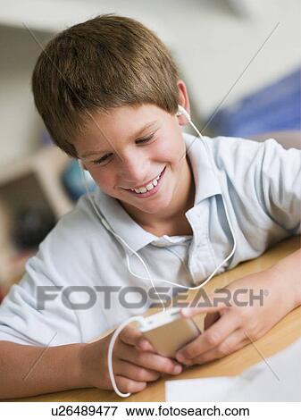 Young Boy Playing With An MP3 Player View Large Photo Image Stock Photo - Young Boy Playing With An MP3 Player. Fotosearch