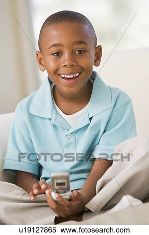 Young Boy Sitting On A Sofa, Text Messaging View Large Photo Image Stock Photography - Young Boy Sitting On A Sofa, Text Messaging. Fotosearch