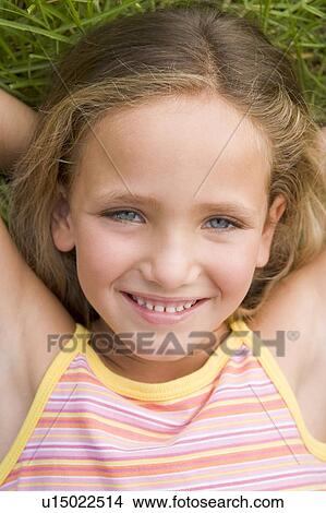 Young Girl Lying Down On The Grass View Large Photo Image Picture - Young Girl Lying Down On The Grass. Fotosearch