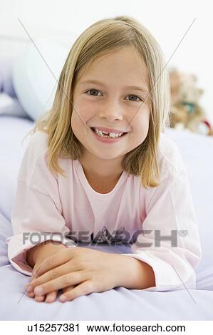 Young Girl Lying On Her Bed In Her Pajamas View Large Photo Image Stock Image - Young Girl Lying On Her Bed In Her Pajamas. Fotosearch