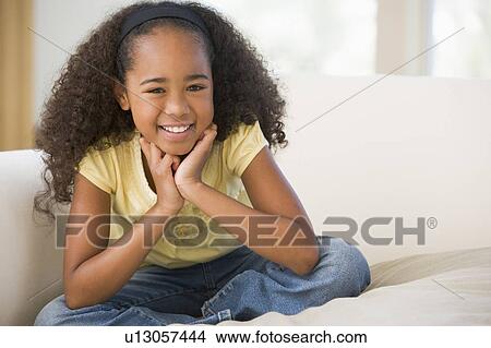 Young Girl Sitting Cross Legged On A Sofa At Home View Large Photo Image Picture - Young Girl Sitting Cross Legged On A Sofa At Home. Fotosearch
