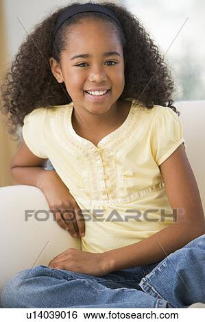 Young Girl Sitting On A Sofa At Home View Large Photo Image Stock Photograph - Young Girl Sitting On A Sofa At Home. Fotosearch
