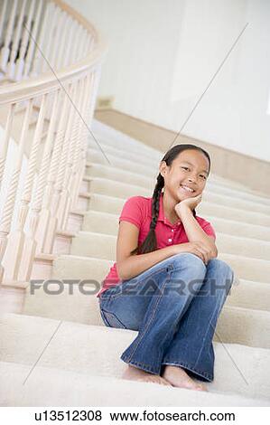 Stock Photo - Young Girl Sitting On A Stairwell At Home. Fotosearch