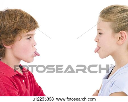 Stock Photo - Brother and sister sticking tongues out at each other. Fotosearch