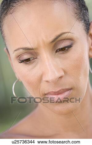 Picture - Head shot of woman scowling. Fotosearch