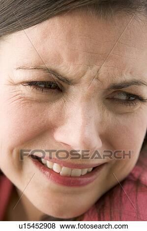 Stock Photo - Head shot of woman scowling. Fotosearch