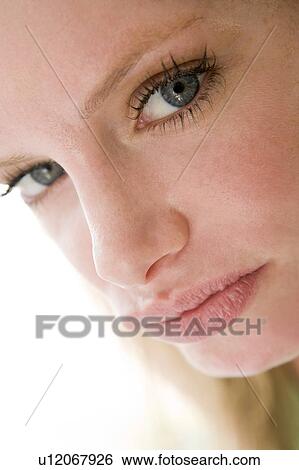Stock Photograph - Head shot of woman scowling. Fotosearch