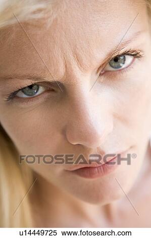 Stock Photography - Head shot of woman scowling. Fotosearch