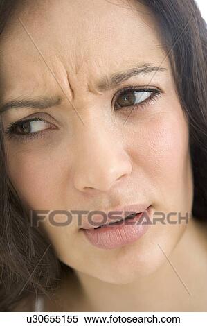 Stock Photography - Head shot of woman scowling. Fotosearch