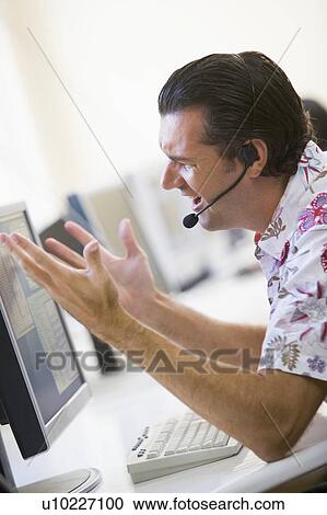 Man in computer room wearing headset looking frustrated View Large Photo Image Stock Image - Man in computer room wearing headset looking frustrated. Fotosearch