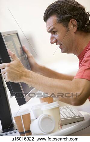 Man in computer room with many empty cups of coffee grabbing his monitor frustrated View Large Photo Image Stock Image - Man in computer room with many empty cups of coffee grabbing his monitor frustrated. Fotosearch