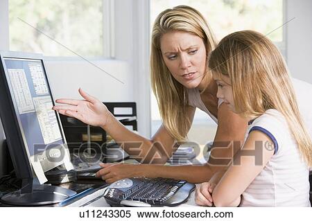 Woman and young girl in home office with computer looking unhappy View Large Photo Image Stock Photography - Woman and young girl in home office with computer looking unhappy. Fotosearch