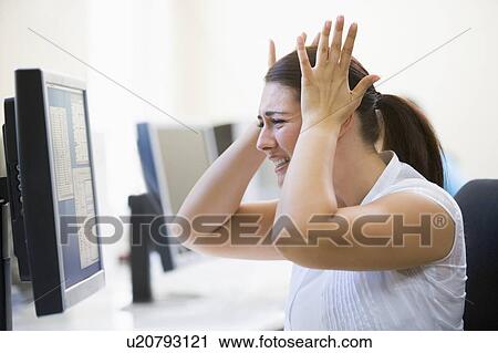 Woman in computer room looking frustrated View Large Photo Image Stock Image - Woman in computer room looking frustrated. Fotosearch