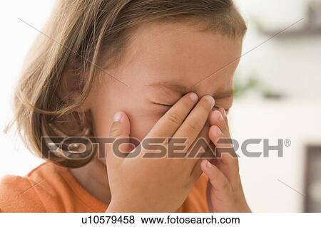 Stock Photo - Young girl indoors crying. Fotosearch