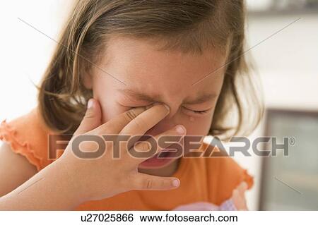 Stock Photograph - Young girl indoors crying. Fotosearch